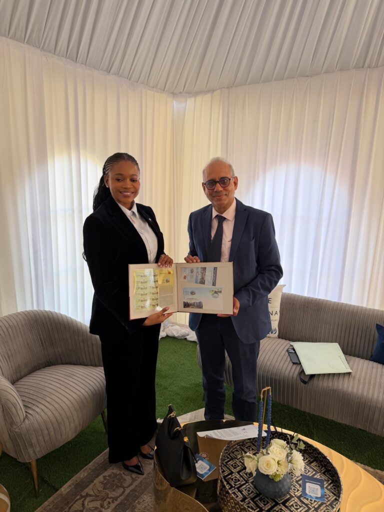 Mehul Shah of Bharat Diamond Bourse presenting BDB postal stamp to Botswana Minister Bogolo Joy Kenewendo during WFDB Summit